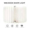 Mini book-shaped LED lamp with USB rechargeability, soft light, 360-degree foldability, and eco-friendly material.