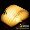 Book lamp with LED lighting, featuring a foldable wooden design emitting warm, white, and natural colors.